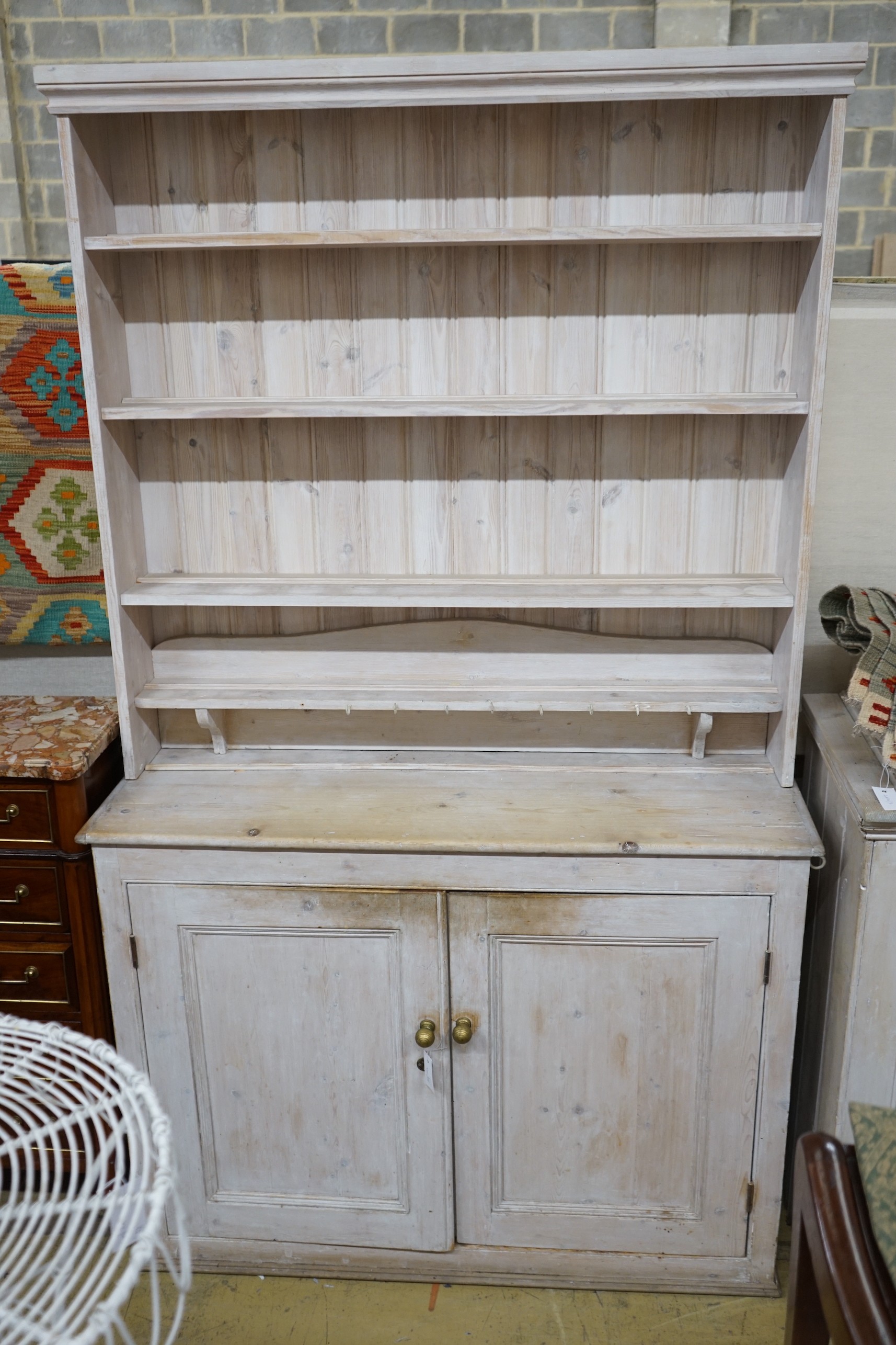 A Victorian painted pine dresser with later boarded rack, length 125cm, depth 42cm, height 215cm